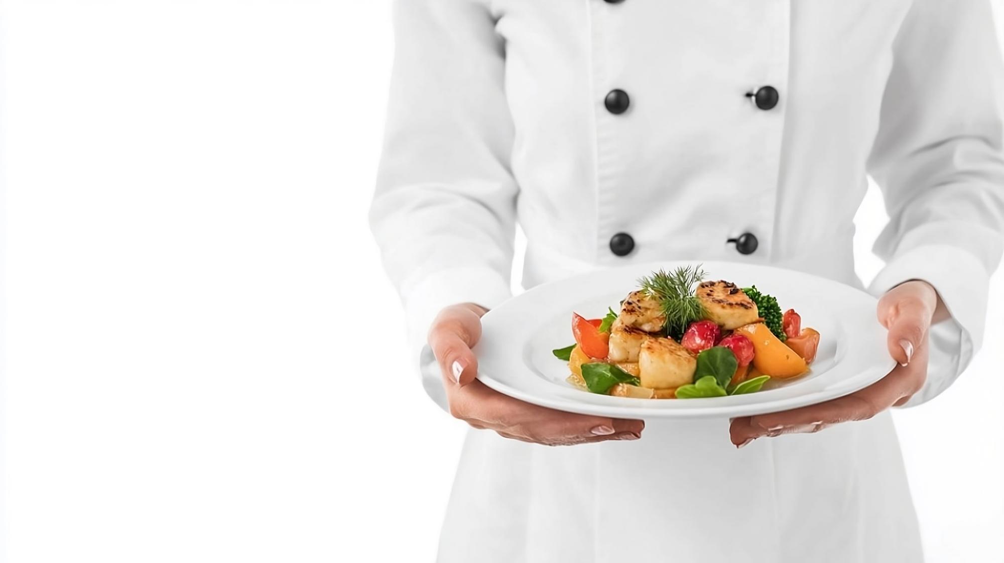Chef presenting plated menu to guests